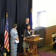 Deb opens the ceremony with KHoF teammate Beth Fager to her right, and Master of Ceremonies Jim Lehrer (news anchor for PBS NewsHour and Wichita native) to her left.