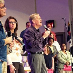 Rev. Robert Brooks (center) leads the congregation in prayer and praise to open the closing night of the Revival services.