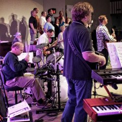 My sister was not too shy to get close so she could get a better picture of the praise band, specifically a better picture of drummer Corey Wilson. I'm on bass (closest to camera), a very dear old friend Dave Fender on Hammond organ (in the far corner), Richie Betsworth on guitar (opposite the drums), and Youth Pastor Brad Thompson on acoustic guitar (out front).